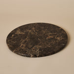 Round Emperador Dark decorative tray with rich brown veining on a soft neutral backdrop