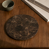 Tavellio Emperador Dark marble tray on a wooden console beside a ceramic bowl and books