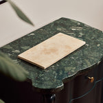Nori medium Classic Travertine tray in light beige stone on a green marble console table