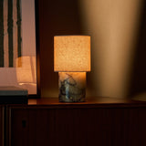 Rechargeable table lamp Onoda Medium Calacatta Vionaro Yellow marble base glowing on a dark sideboard