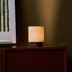 Tafellamp oplaadbaar Onoda Small in Rosso Levanto rood marmer op een donkere houten kast
