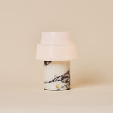 Pissarro rechargeable table lamp with two-tier opal shade and red marble base under spotlight