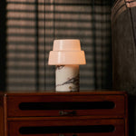 Cordless table lamp with two-tier opal glass shade and red marble base on wooden sideboard