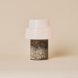Pissarro cordless table lamp in silver travertine stone shown on a plain studio background