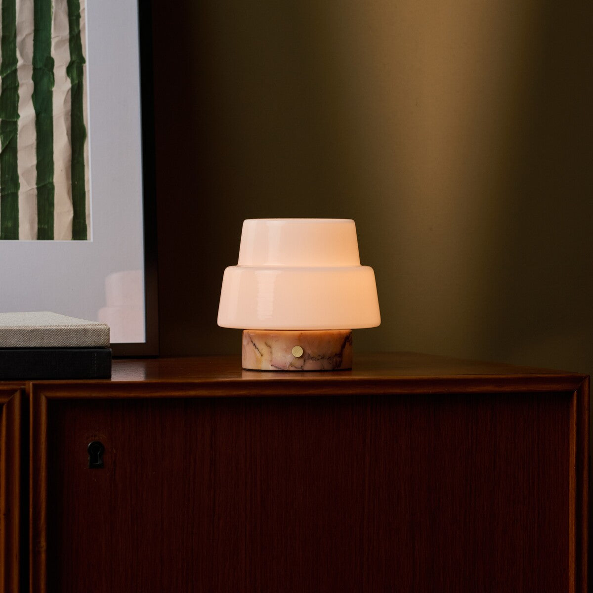 Rechargeable table lamp Pissarro Small Calacatta Vionaro Pink Marble glowing on a wooden dresser
