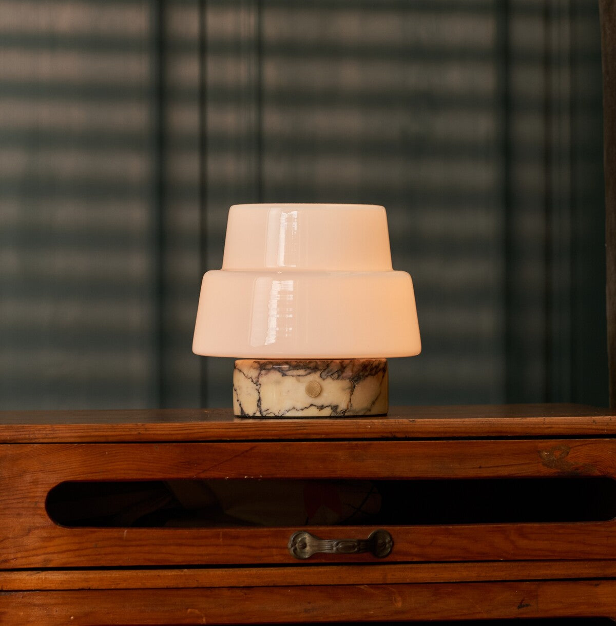 Rechargeable table lamp Pissarro Small Calacatta Vionaro Yellow Marble lit on a wooden dresser