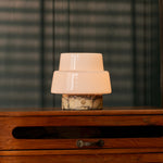 Rechargeable table lamp Pissarro Small Calacatta Vionaro Yellow Marble lit on a wooden dresser