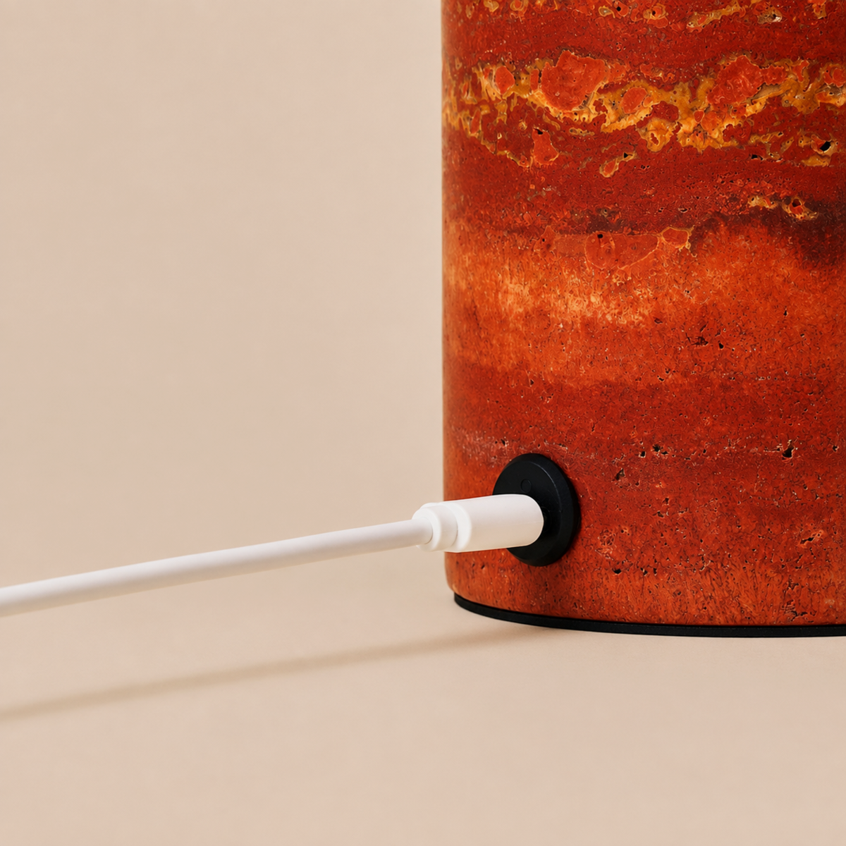 Close-up of the Red Travertine stone base and USB charging port on the Maes table lamp