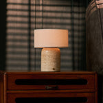 Redon Large rechargeable table lamp in beige travertine marble on a soft cream studio backdrop
