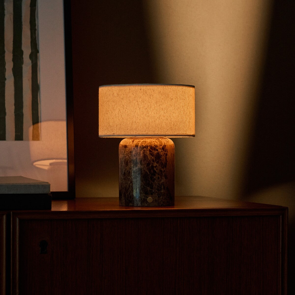 Rechargeable table lamp Redon Large Emperador Dark marble base glowing on dark wood cabinet