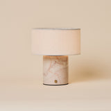 Redon cordless table lamp featuring a rosa aurora pink marble base and linen drum shade