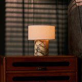Cordless table lamp Redon in yellow Calacatta Vionaro marble on a wooden dresser