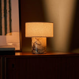 Cordless table lamp Redon in Calacatta Vionaro yellow marble with round linen shade, close-up view