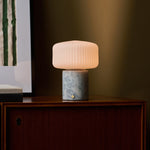 Renoir Medium rechargeable table lamp with blue calcite marble base and ribbed glass shade on sideboard