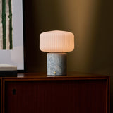 Renoir Medium rechargeable table lamp with blue calcite marble base and ribbed glass shade on sideboard