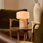 Renoir Medium rechargeable table lamp in honey onyx marble with ribbed glass shade, studio shot
