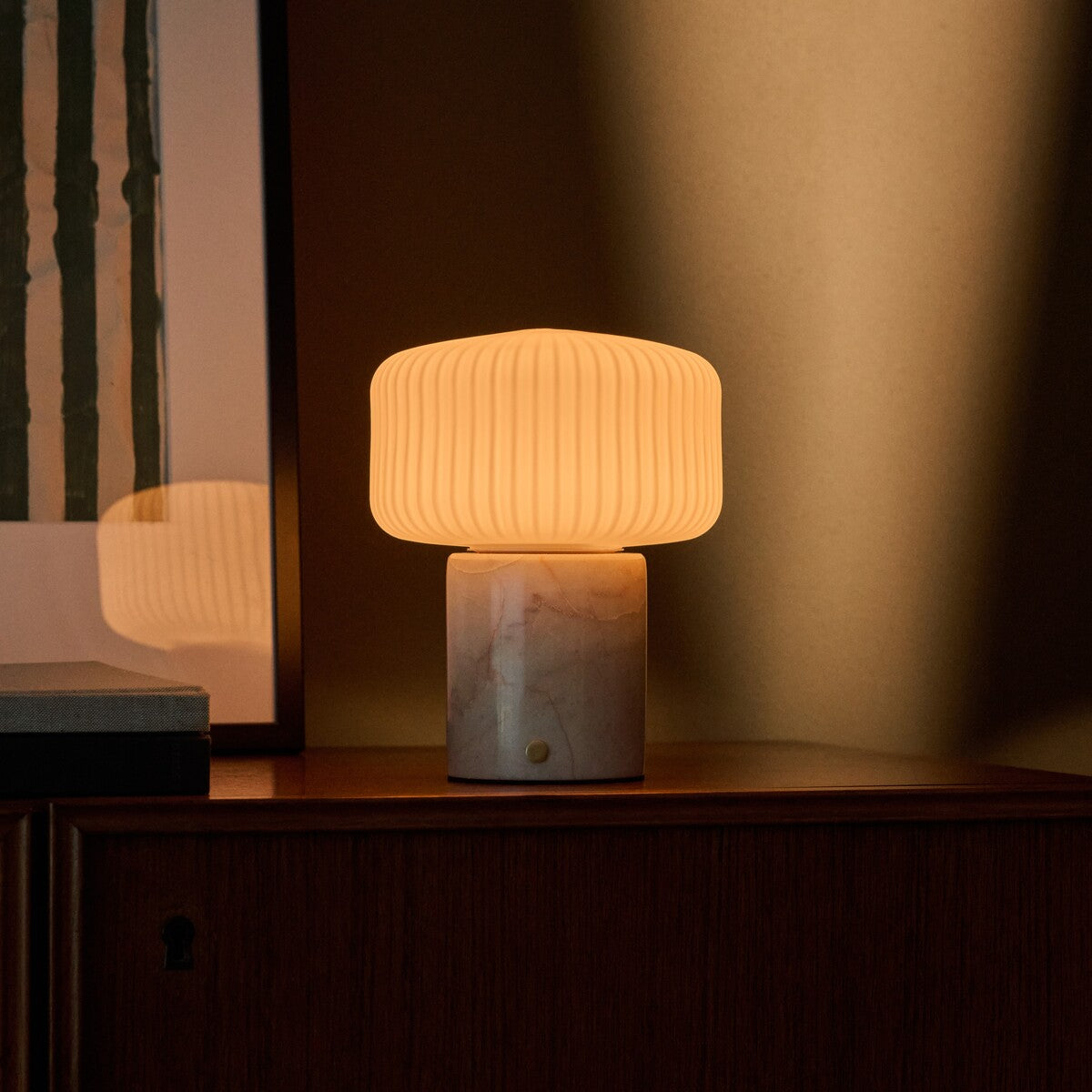 Renoir Medium cordless table lamp with rosa aurora pink marble base and warm ribbed glow