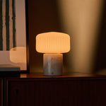 Renoir Medium cordless table lamp with rosa aurora pink marble base and warm ribbed glow