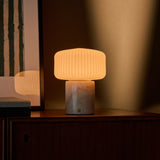 Renoir Medium cordless table lamp with rosa aurora pink marble base and warm ribbed glow