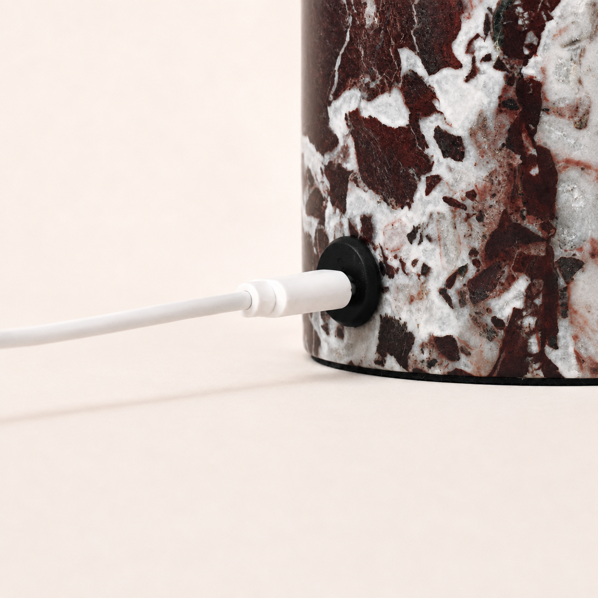 Magnetic charging cable connected to the Hooch Small Rosso Levanto marble lamp base