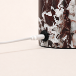 Magnetic charging cable connected to the Hooch Small Rosso Levanto marble lamp base