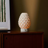 Cordless table lamp Serena Arabescato marble, cream porcelain shade glowing on wood sideboard