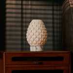Cordless table lamp Serena Arabescato marble, glowing porcelain shade on vintage wooden dresser