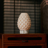 Cordless table lamp Serena Arabescato marble, glowing porcelain shade on vintage wooden dresser