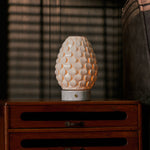 Close-up of the Serena Bianco Statuarietto cordless table lamp's white marble base held on someone's lap