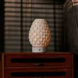 Close-up of the Serena Bianco Statuarietto cordless table lamp's white marble base held on someone's lap