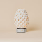 Serena Bianco Statuarietto marble rechargeable table lamp with scalloped porcelain shade on a beige backdrop