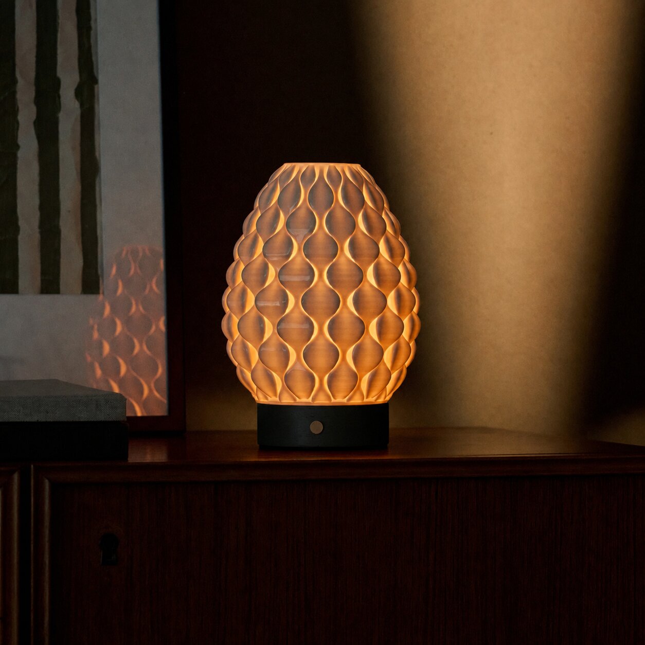 Cordless Serena black wood table lamp with textured porcelain shade in a dim room