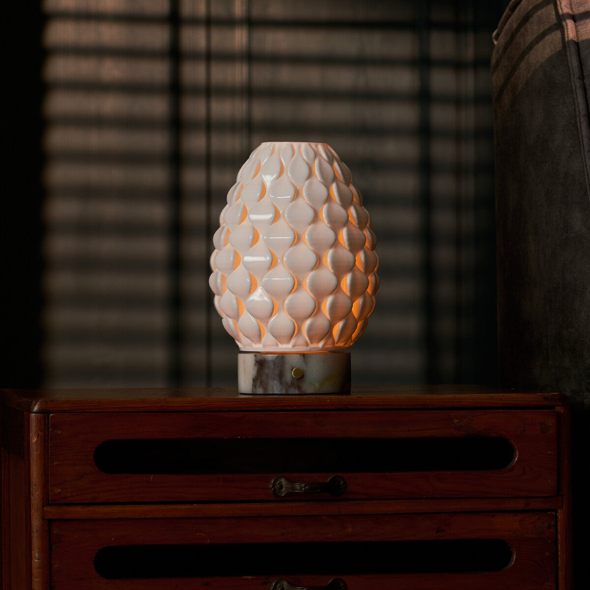 Serena rechargeable table lamp with Calacatta Viola marble base on a dark wood dresser