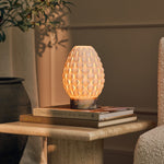 Serena rechargeable table lamp with Calacatta Viola marble base on a travertine side table