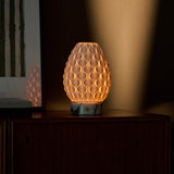 Serena cordless table lamp lit on wooden sideboard, white marble base, warm evening glow