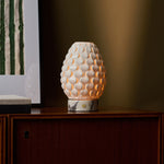 Serena rechargeable table lamp glowing at dusk, white marble base, styled interior setting