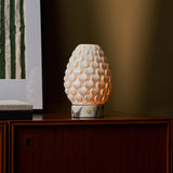 Serena rechargeable table lamp glowing at dusk, white marble base, styled interior setting