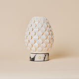 Serena rechargeable table lamp, white porcelain petal shade on white marble base, studio shot