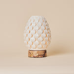 Serena rechargeable table lamp, white porcelain petal shade on pink marble base, studio shot