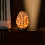 Serena cordless table lamp glowing warm light, pink marble base, styled on wooden sideboard