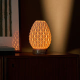Serena cordless table lamp glowing warm light, pink marble base, styled on wooden sideboard
