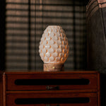 Serena rechargeable table lamp lit on nightstand, pink marble base, warm ambient bedroom light