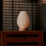 Serena rechargeable table lamp lit on nightstand, pink marble base, warm ambient bedroom light
