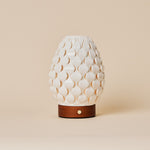 Cordless table lamp Serena Chestnut wooden base, ribbed porcelain shade on beige studio background