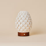 Cordless table lamp Serena Chestnut wooden base, ribbed porcelain shade on beige studio background