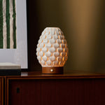 Cordless table lamp Serena Chestnut wooden base, textured porcelain shade on dark wood cabinet