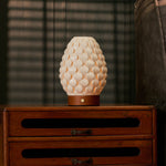 Rechargeable table lamp Serena Chestnut wooden base, dimmable porcelain shade against striped blinds