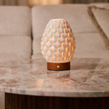 Rechargeable table lamp Serena Chestnut wooden base, glowing porcelain shade on marble side table