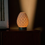 Cordless table lamp Serena Ice Green marble, dimmable porcelain shade glowing against striped blinds