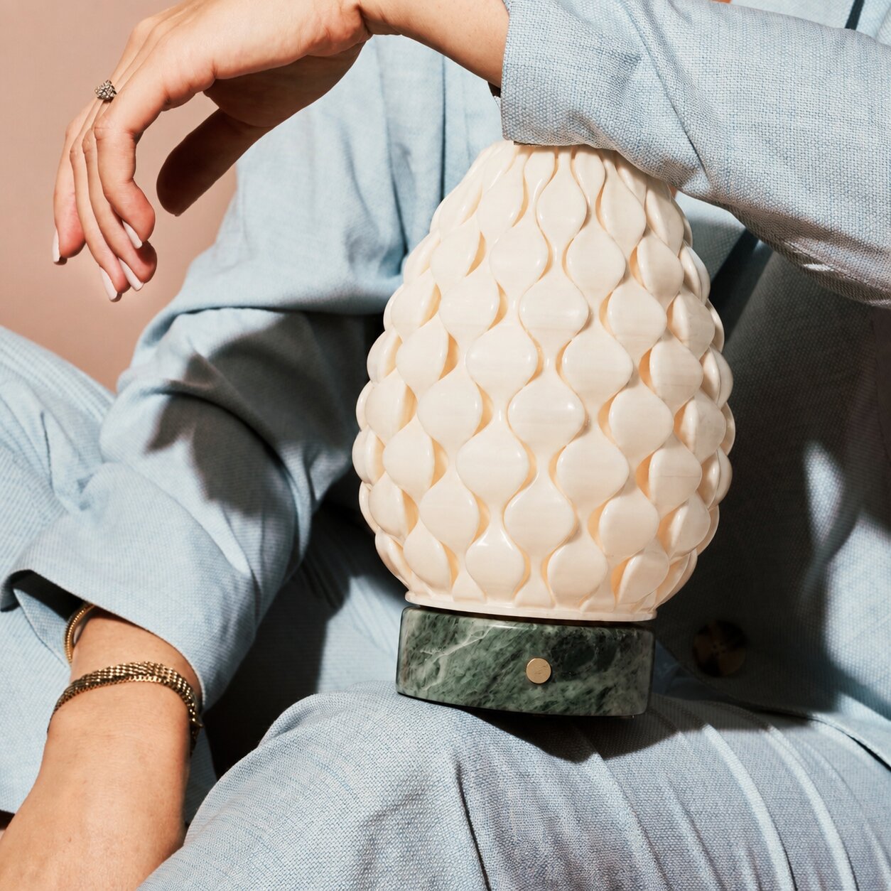 Cordless table lamp Serena Ice Green marble, textured porcelain shade held close in hand